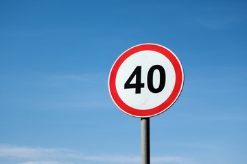 Fototapeta International traffic sign 'Speed limit' (to 40 km per hour). Blue sky is on  background obraz