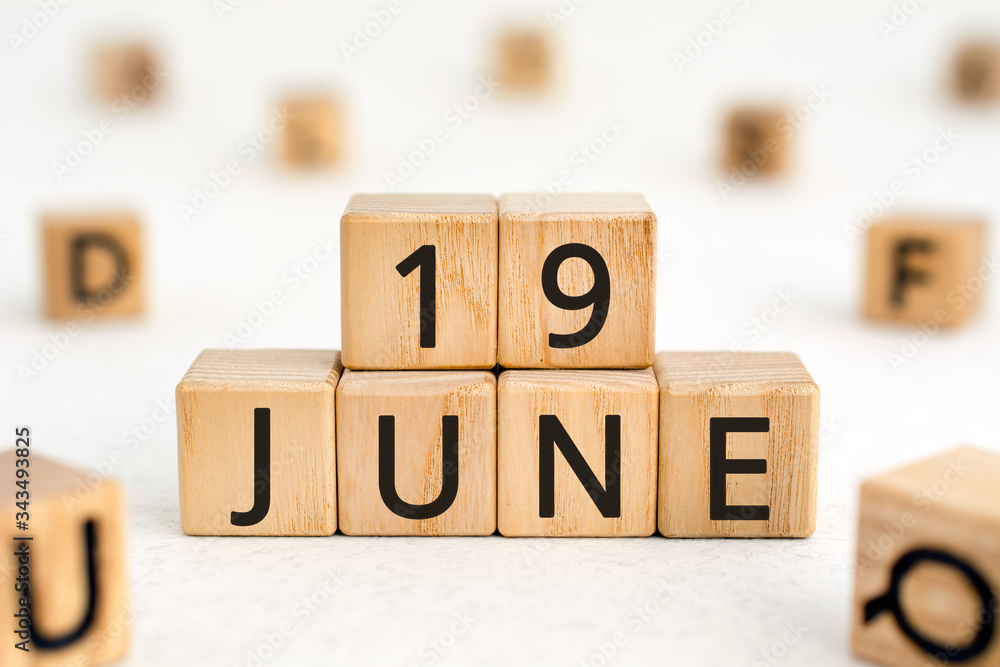 Poster june 19- from wooden blocks with letters, important date concept, white background random letters ar