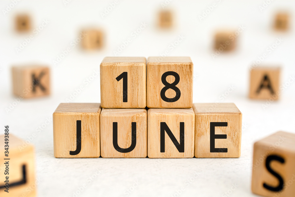 Poster june 18 - from wooden blocks with letters, important date concept, white background random letters a