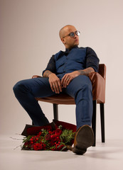 man in a chair with flowers