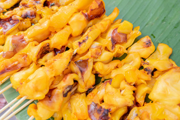 A Pile of squid sticks on a banana leave