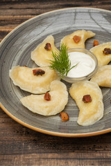 Dumplings with potato on wooden background