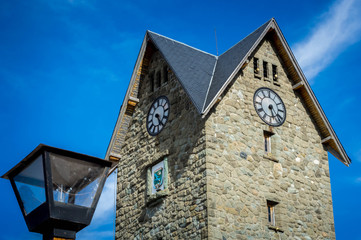 Fototapeta na wymiar Clock tower of the civic center of Bariloche, Argentina. A sunny day in March.