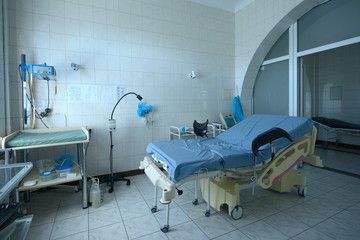 Obstetric bed at the delivery room of the maternity hospital, medical equipment set