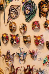 Carnival attribute with ornament. Traditional venetian golden mask in store on street, Italy. Annual carnival in Venice which the most famous in Europe. Symbol of Venice. Shop souvenir. Сelebration.