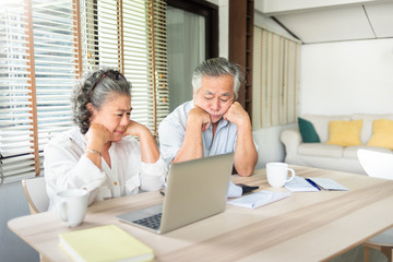 Worried Senior man and woman having problem about Debts. Saving, Financial and economic crisis