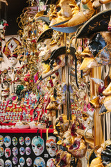 Carnival attribute with ornament. Traditional venetian golden mask in store on street, Italy. Annual carnival in Venice which the most famous in Europe. Symbol of Venice. Shop souvenir. Сelebration.