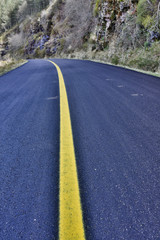 Naklejka premium old road crossed by yellow line
