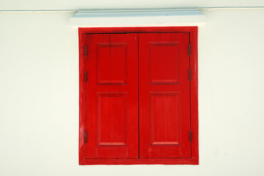 Red Wooden door on white wall texture background - abstract surface with copy space                                