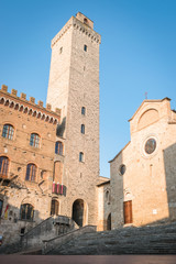 Fototapeta premium View of the famous towers from the historic center of the village of San Gimignano, a heritage of humanity, on a summer morning