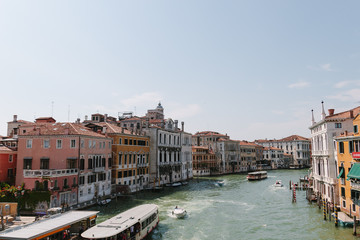 Street of Venice in summer time. Italian view. Roof, sea canal, boat in sunny day. Old city, ancient buildings.  Italy. Basilica Santa Maria della Salute. Popular tourist destination of Italy. 