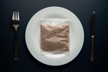 Coronavirus diet. Pack of raw buckwheat on the plate