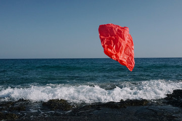 Flying garbage bag on a background of the sea.