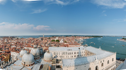 Fototapeta na wymiar Venice in summer time. Italian view. Roof, sea, boats in sunny day. Old city, buildings. Popular tourist destination of Italy. Europe. Top view from Saint mark's tower. Palazzo Ducale. Doge's Palace.