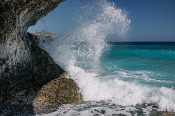 Sea wave hits a rock.