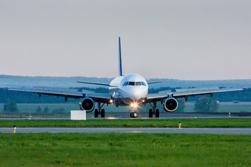 Fototapeta na wymiar U-turn of a passenger jet plane on the runway. Front view