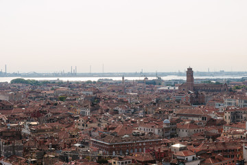 Venice in summer time. Italian view. Roof, sea, boats in sunny day. Old city, ancient buildings. Popular tourist destination of Italy. Europe. Top view from Saint mark's tower. Torre dell'orologio.