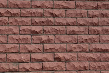 Obraz premium Brickwork uneven surface of red-brown color.