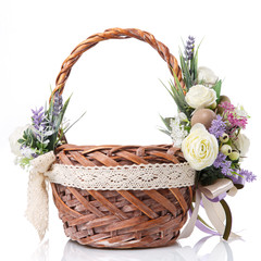 Fototapeta na wymiar Natural wicker basket with flowers and ribbons. Beautiful bow on the side. Isolated