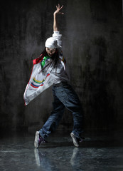 Young beautiful dancer is posing in studio