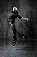 Young beautiful dancer is posing in studio
