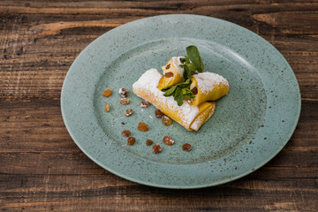 Pancakes in plate on a wooden background