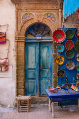 Fototapeta na wymiar Essaouira, Morocco - 01.03.2020: Little colorful and charming local shop at the streets of Essaouira, a town at the Atlantic coast of Morocco