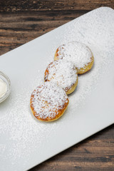 Cheesecakes on plate on wooden background