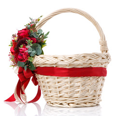 Fototapeta na wymiar Easter basket made of natural vines with handmade decor in red. Basket with floral decoration.
