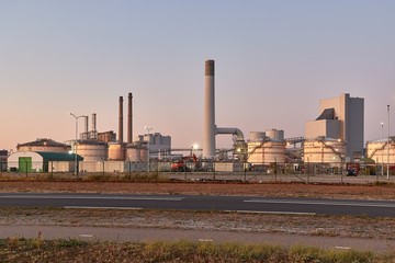 Fototapeta na wymiar Power plant and oil silos in an industrial area in the Port of Rotterdam