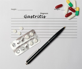 Gastritis diagnosis written on a white piece of paper.