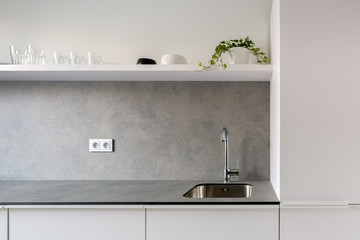 Simple kitchen sink in gray countertop