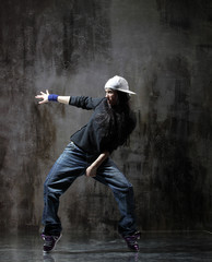 Young beautiful dancer is posing in studio