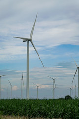 Windmill for renewable electric energy production at huai bong, dan khun thot district, nakhon ratchasima, thailand against cloudy blue sky background