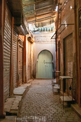 Marrakech, Morocco - 12.27.2019: Beautiful edges of the narrow Marrakech Medina streets with orange and brown building al around
