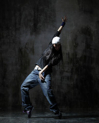 Young beautiful dancer is posing in studio