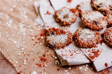 Closeup of an oatmeal, banana, pure cocoa and coconut cookies on recycled paper and cloth tablecloth