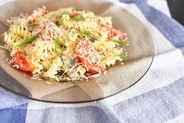pasta in a creamy sauce with mushrooms and tomatoes and cheese