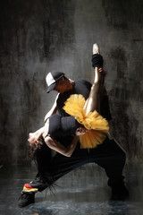 modern dancers posing in front of the old dirty wall