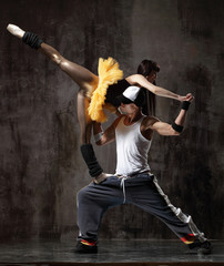 modern dancers posing in front of the old dirty wall