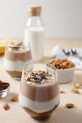 Chia seeds pudding with chocolate and banana smoothie in a glass