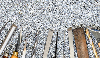 set of craft tools on gravel background