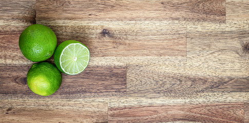 green lime on wooden table background