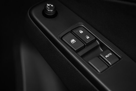 Car control panel auto button glass in a luxury car.automatic window lifter button on a modern car