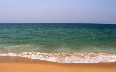 Aqua green blue waters off the coast of ocean with golden sands