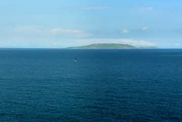 Lonely yacht on the background of a distant island.Ireland.