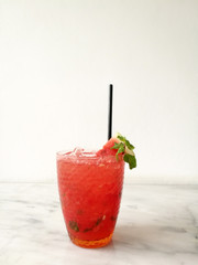 Drink scene of Ice Red soda Mix with passion fruit juice on Striped marble Table and white Texture background