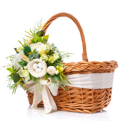 Fototapeta na wymiar Easter basket on white background. It is decorated with a large decoration in green tones of flowers, greens and a small decorative nest. Ribbons and lace.