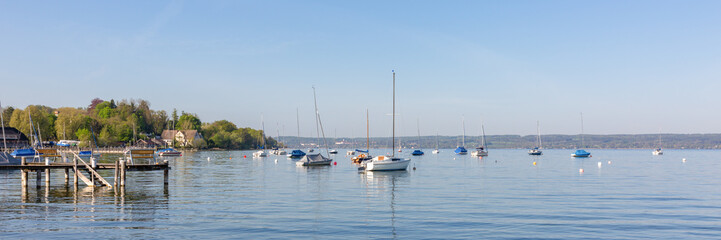 Fototapeta na wymiar Panorama of Ammersee (Lake Ammer) with pier and anchoring sailboats