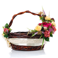 Dark brown wicker basket with original handle and floral decoration on a white background. Decor of...